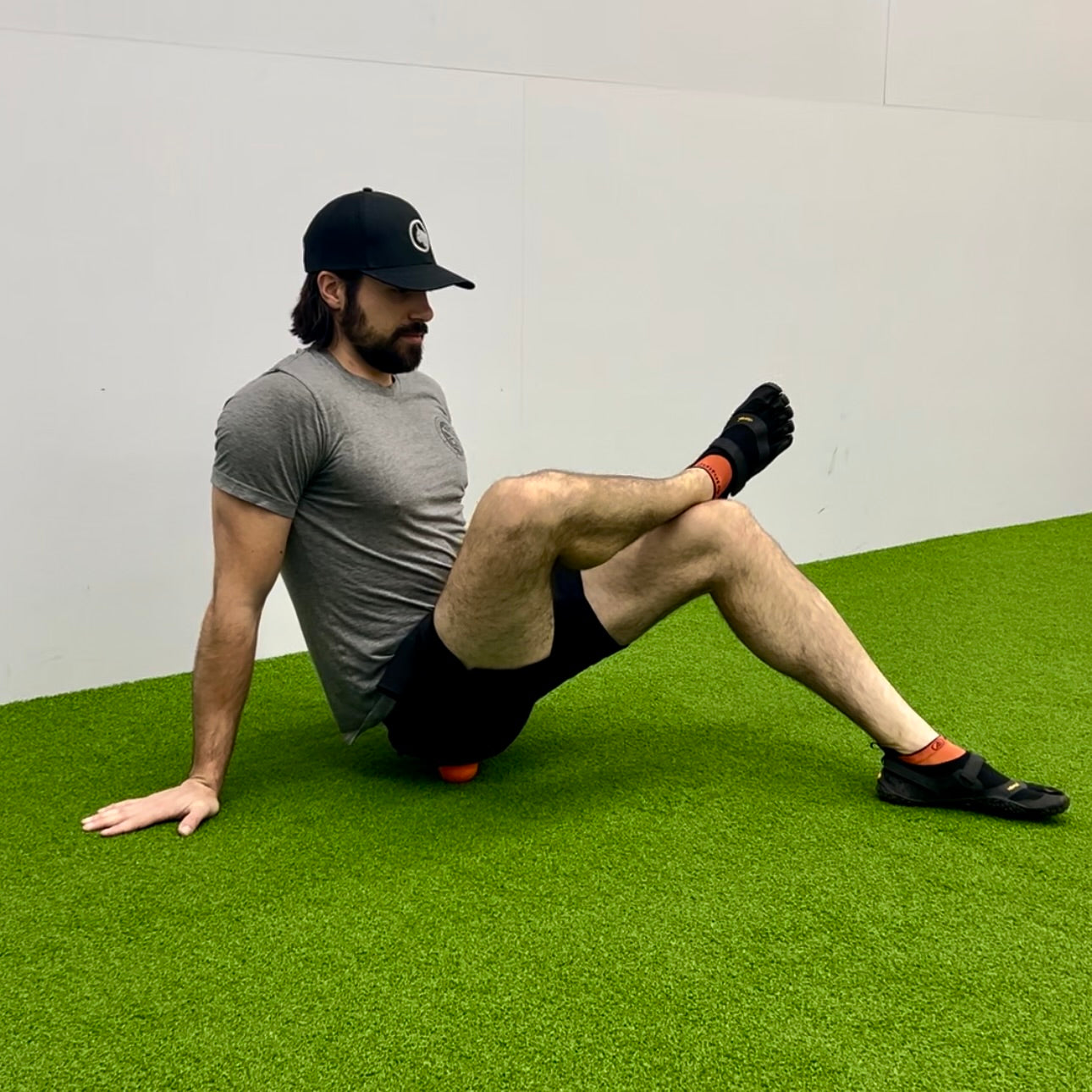 Man using lacrosse ball to massage glutes