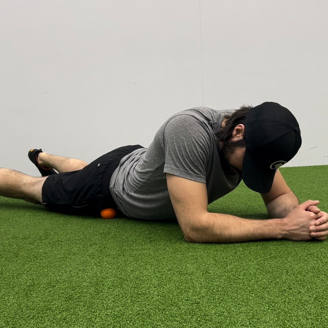 Man using lacrosse ball to release tension in the hip flexors