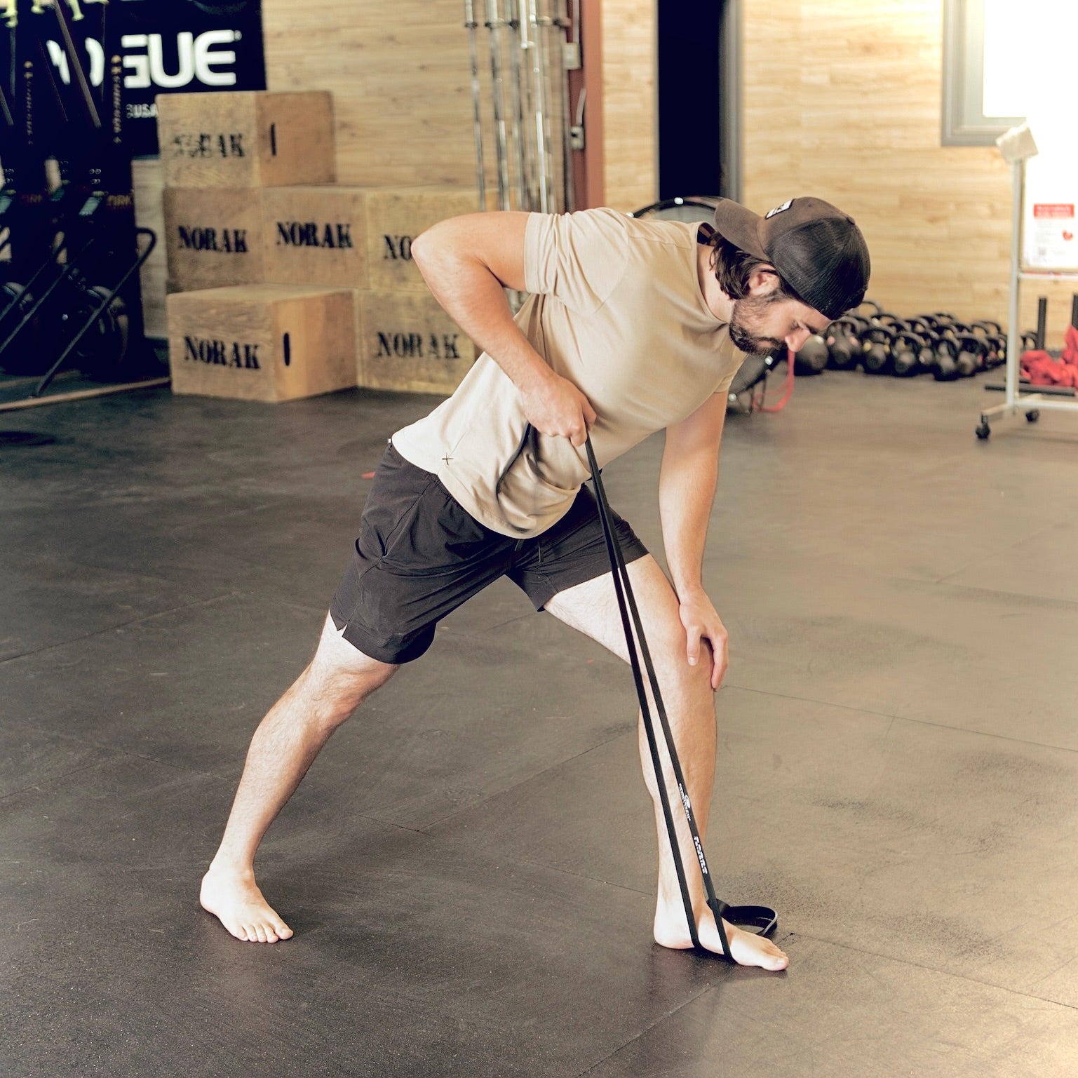 Man using exercise band to strengthen lats and back muscles