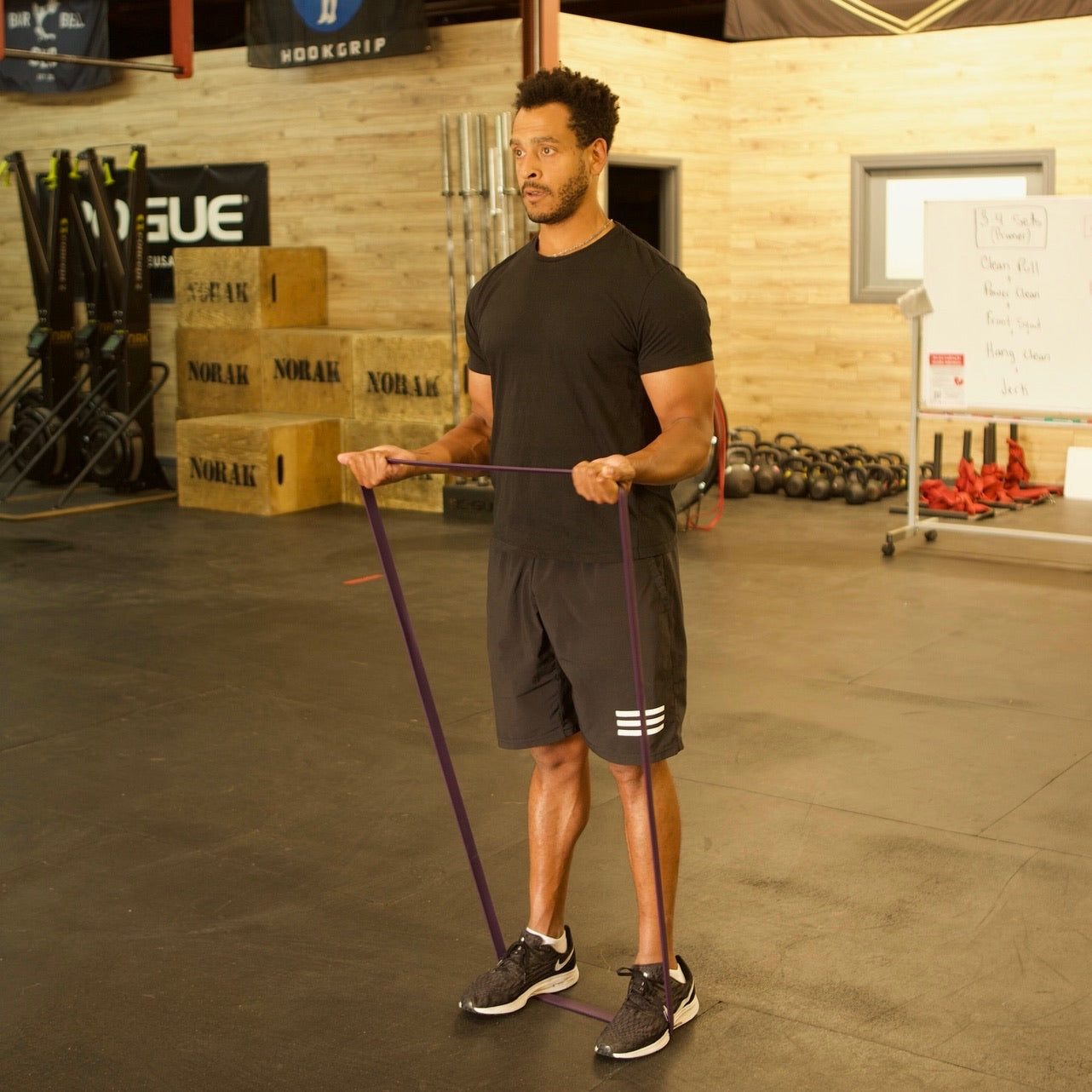 Man using medium intensity exercise band to strengthen his biceps and arms